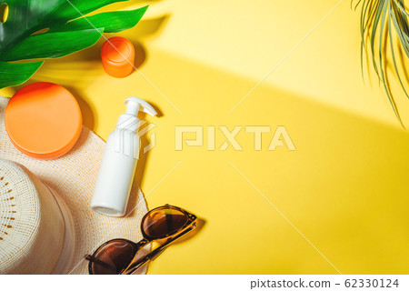 Sunscreen. Woman's hat with sunglasses and protection cream spf Beach accessories. Summer Travel Vacation Concept Sunscreen. Woman's hat with sunglasses and protection cream spf Beach accessories. Summer Travel Vacation Concept 62330124