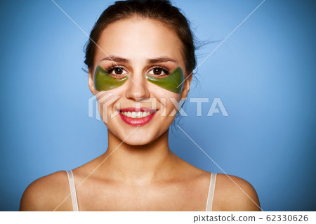 Beautiful young girl with green patches under eyes 62330626