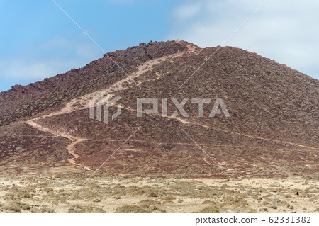 Montana Roja mountain on Tenerife coast near El Medano, Canary Islands, Spain, sunny summer day Montana Roja mountain on Tenerife coast near El Medano, Canary Islands, Spain, sunny summer day 62331382