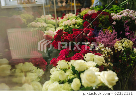 Different varieties fresh spring flowers in refrigerator room for flowers. Beautiful flowers in cold room with air conditioning. Bouquets on shelf, florist business in refrigerator for flowers. Tulinp 62332151