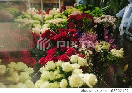 Different varieties fresh spring flowers in refrigerator room for flowers. Beautiful flowers in cold room with air conditioning. Bouquets on shelf, florist business in refrigerator for flowers. Tulinp Different varieties fresh spring flowers in refrigerator room for flowers. Beautiful flowers in cold room with air conditioning. Bouquets on shelf, florist business in refrigerator for flowers. Tulinp 62332152