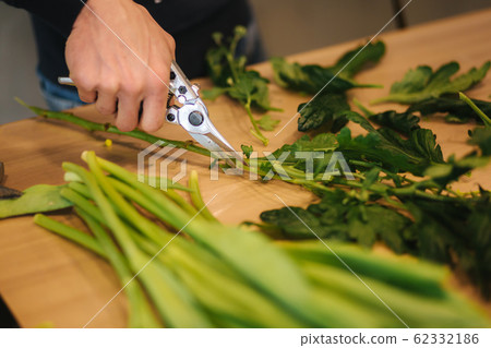 Working place of floristic. Yellow tulips lilac on wooden table 62332186