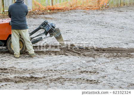 Digging a pipe in the workers installing 62332324