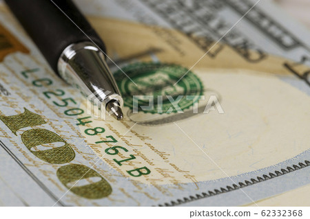 Dollars hundred bills cash money with a pen 62332368