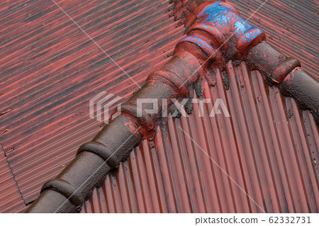 slope roof covers house ribbed tiles close-up 62332731