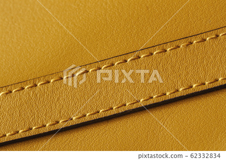 Detail of handbag with stitching, genuine leather of bright yellow color. Texture and fashionable background, copy space Detail of handbag with stitching, genuine leather of bright yellow color. Texture and fashionable background, copy space 62332834