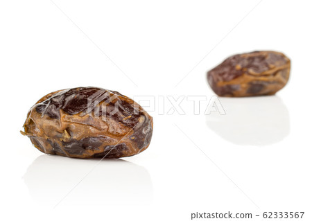 Dry brown date fruit isolated on white Dry brown date fruit isolated on white 62333567