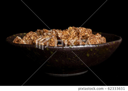 Cereal cocoa heart isolated on black glass Cereal cocoa heart isolated on black glass 62333631