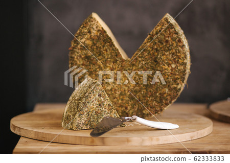 Big piece of lactose-free cheese on wooden board Big piece of lactose-free cheese on wooden board 62333833