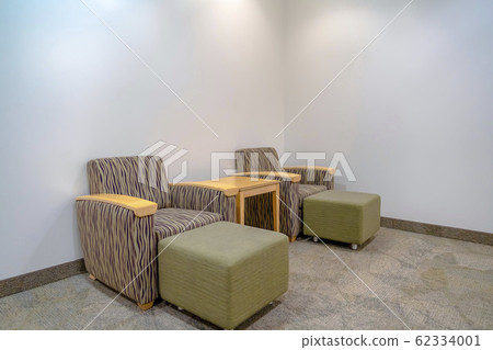 Armchairs with foot rests against white wall 62334001