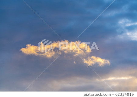 Puffy clouds illuminated by sunlight in the 62334019