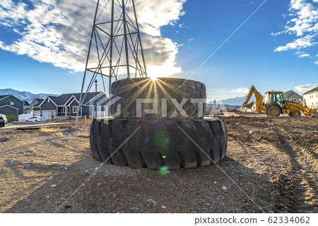 Sun in the cloudy blue sky shining brightly behind Sun in the cloudy blue sky shining brightly behind 62334062