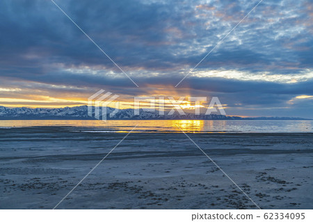 Golden sun reflected on the glistening lake with 62334095