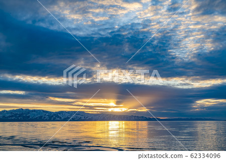 Golden sun shining through the cloudy sky and 62334096