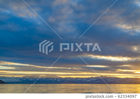 Scenic panorama of a lake and snow capped mountain 62334097