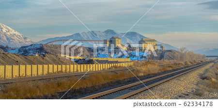 Railway track passing in front of a mining area Railway track passing in front of a mining area 62334178