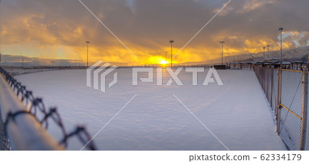 Stunning winter scenery with a golden sun setting 62334179