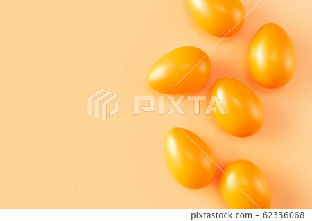 Bright orange Easter eggs seeing form above on light background Bright orange Easter eggs seeing form above on light background 62336068