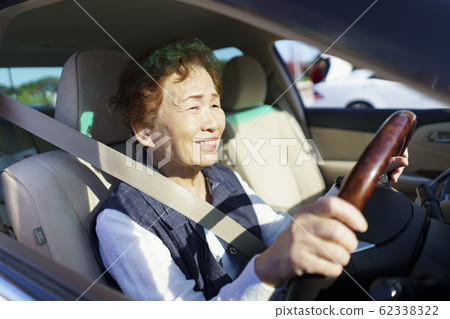 Active senior woman driving Active senior woman driving 62338322
