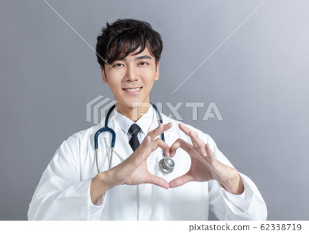 Close up of doctor's hands making heart shape 62338719