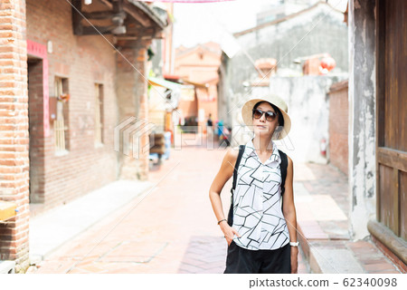 woman walking in the old street at Lukang town woman walking in the old street at Lukang town 62340098