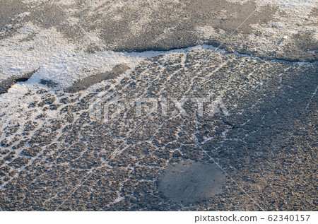 Road surface with powdered snow 62340157