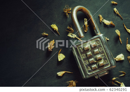 Combination padlock on blackboard background. Top view and copy space. Concept of safety and secret in vintage style. Combination padlock on blackboard background. Top view and copy space. Concept of safety and secret in vintage style. 62340291