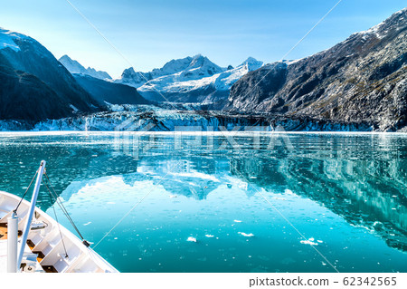 Cruise ship in Glacier Bay cruising towards Johns Hopkins Glacier in Alaska, USA. Panoramic view during summer 62342565