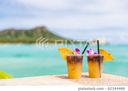 Hawaii mai tai drinks on waikiki beach bar travel vacation in Honolulu, Hawaii. Famous hawaiian drink cocktails with view of ocean and diamond head mountain, Hawaii tourist attraction 62344466
