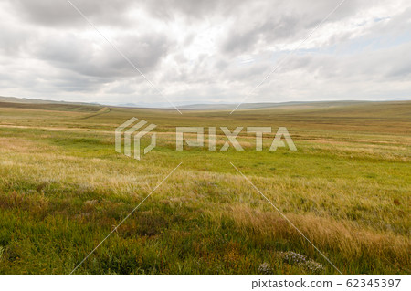 Mongolian steppe on the background of a cloudy sky 62345397