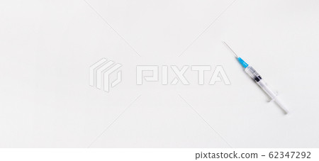Vaccination concept. Syringe with vaccine on gray 62347292