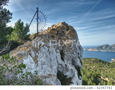 Sharp rocky side above valley with view to sea Sharp rocky side above valley with view to sea 62347781