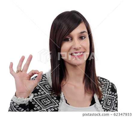 young brunette woman making ok sign, on white young brunette woman making ok sign, on white 62347933