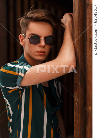Handsome young stylish man model with hairdo Handsome young stylish man model with hairdo 62349617