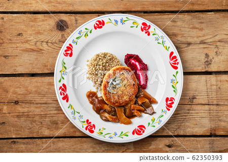 Top view of meat cutlet with honey mushroom and 62350393