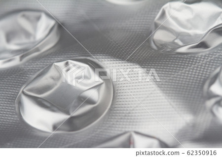 macro closeup of damaged medical pills blister 62350916