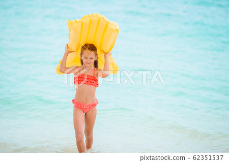 Cute little girl enjoy vacation in the swimming pool 62351537
