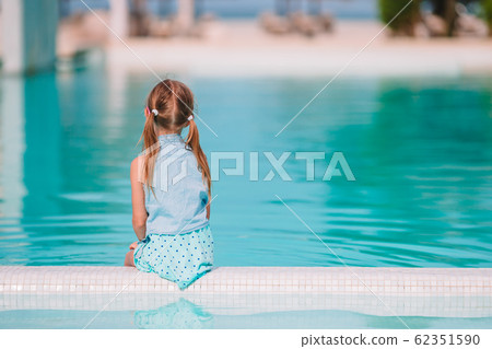 Little adorable girl in outdoor swimming pool 62351590