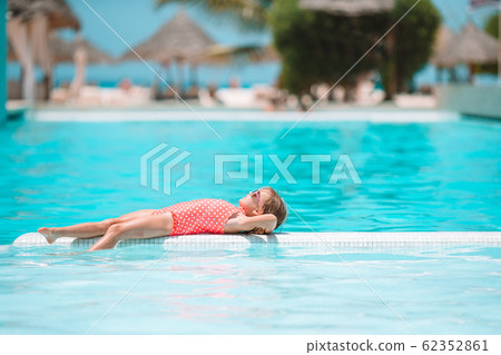 Little adorable girl in outdoor swimming pool 62352861