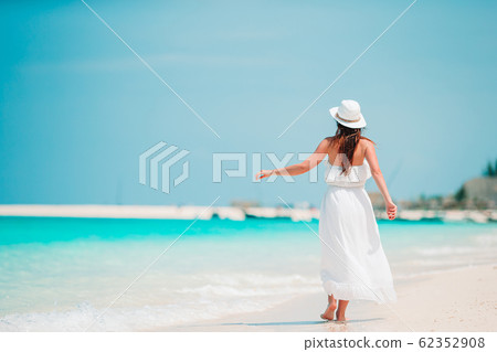 Young fashion woman in green dress on the beach Young fashion woman in green dress on the beach 62352908