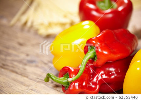 sweet peppers, wooden table background sweet peppers, wooden table background 62355440