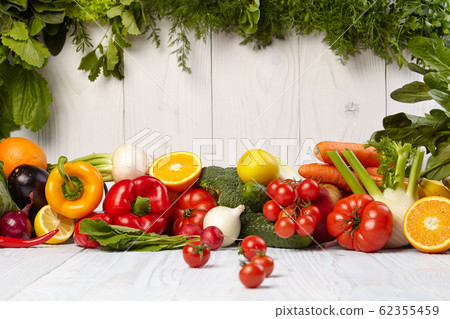 Fruit and vegetable borders on white wooden table 62355459