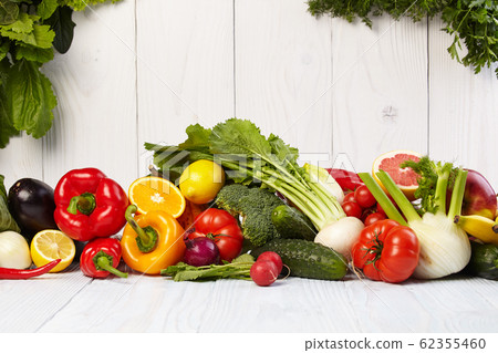 Fruit and vegetable borders on white wooden table 62355460