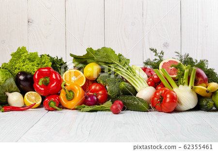 Fruit and vegetable borders on white wooden table 62355461