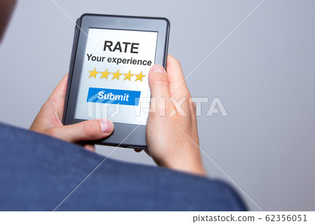 Businessman hands holding tablet with Rate your Businessman hands holding tablet with Rate your 62356051