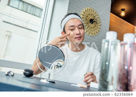 Makeup boy: A man who cares about his skin and applies a foundation Makeup boy: A man who cares about his skin and applies a foundation 62356064