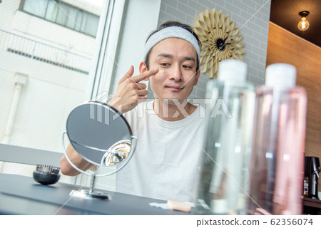Makeup boy: A man who cares about his skin and applies a foundation Makeup boy: A man who cares about his skin and applies a foundation 62356074