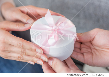 Hand up of young men and women who hand presents 62356429