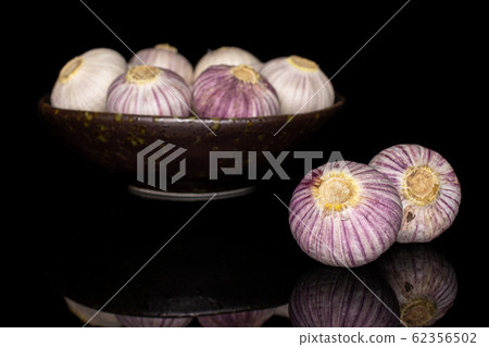 Single clove garlic isolated on black glass Single clove garlic isolated on black glass 62356502