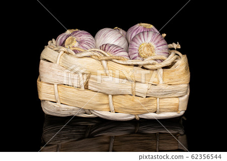 Single clove garlic isolated on black glass 62356544